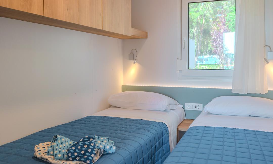 Twin room with single beds and bright window.